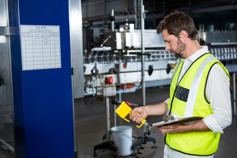male-worker-using-machinery-juice-factory